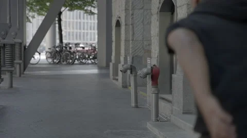 Slow Motion Tracking And Panning A Young Man As He Sprints Across A City Stock Footage 154589836