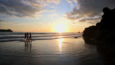 Slow motion tracking shot of 3 women walking on the beach Stock Footage 235563002