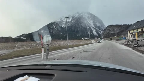 Slow Motion Tracking Shot From Car Driving Past Snowy Alps Mountains Video stock 328694883