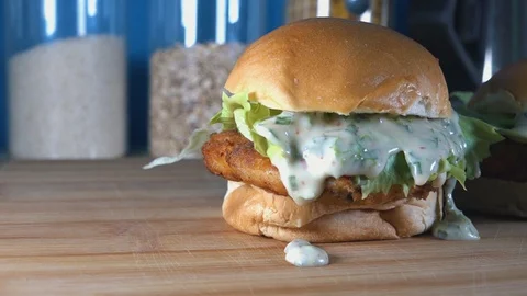 Slow Motion Tracking Shot of Crispy Homemade Fish Cake Sliders on a Wooden Stock Footage 113396129