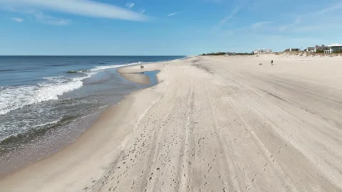 Slow Motion Tracking Shot Down a Beach Stock Footage 271141385