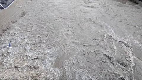 Slow Motion Tracking Shot Of Flood Water Overrunning River Bank Stock Footage 328842477