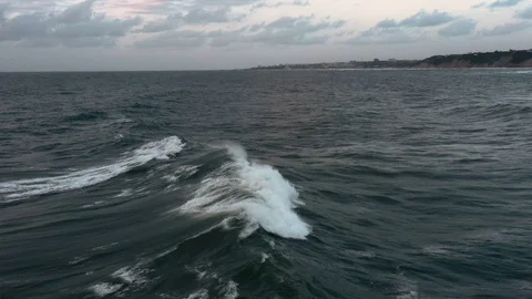 Slow-motion tracking shot of storm waves breaking at sunset Stock Footage 112703652