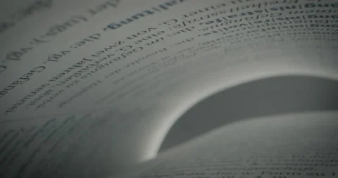 Slow motion tracking shot through slowly opening book Stock Footage 220603609
