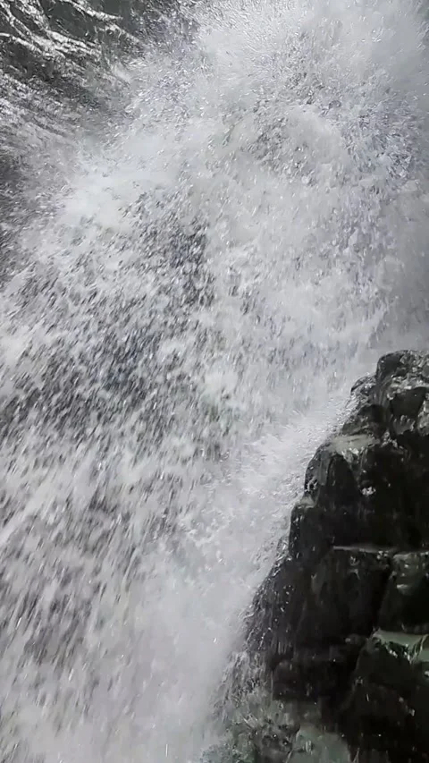 Slow Motion Tracking Shot of Water Falling from a Waterfall Stock Footage 328297876