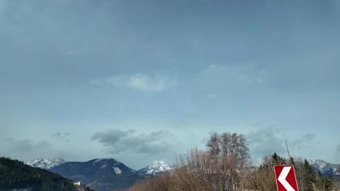 Slow Motion Tracking Shot Of Winter Forest And Peaks From Moving Car Stock Footage 328695064