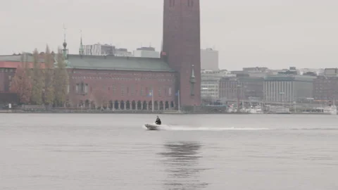 Slow motion tracking a small rib boat in down town Stockholm Stock Footage 143265627