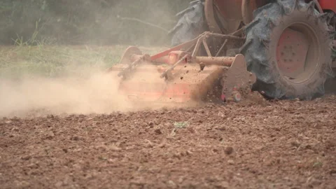 Slow motion tractor plowing and working prepare soil land for plantation in farm Stock-Footage 136056364