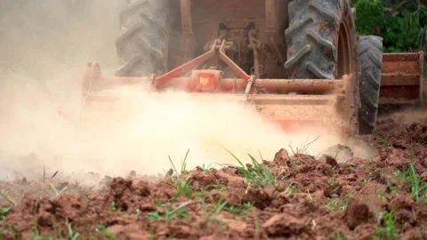 Slow motion tractor plowing in field of farmland of agriculture Stock Footage 140396987