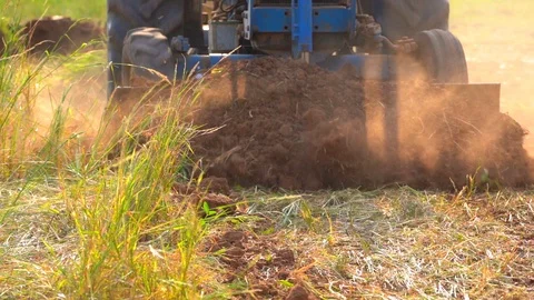 Slow motion tractor plowing soil grass filed farm agriculture for planting tree 库存影片 106664128