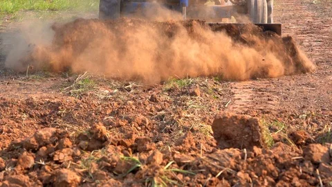 Slow motion tractor plowing soil grass filed farm agriculture for planting tree 库存影片 106664345