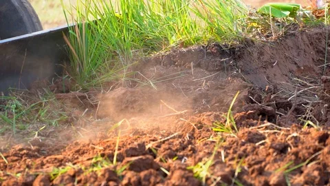 Slow motion tractor plowing soil grass filed farm agriculture for planting tree Stock Footage 106664621