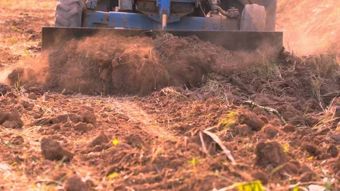 Slow motion tractor plowing soil in farmland for planting agriculture Stock Footage 107117618