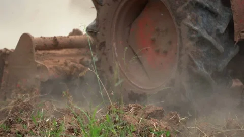 Slow motion tractor plowing soil in farm agriculture, preparation for seeding pl Stock Footage 145546288