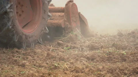 Slow motion tractor plowing soil land of farm agriculture  Stock Footage 147187751