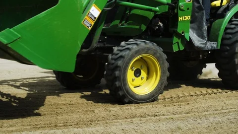 Slow motion tractor wheels pulling a drag harrow Stock Footage 130144874