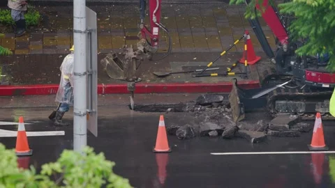 Slow motion of traffic passing construction area on rainy street in Taipei Stock Footage 313628253