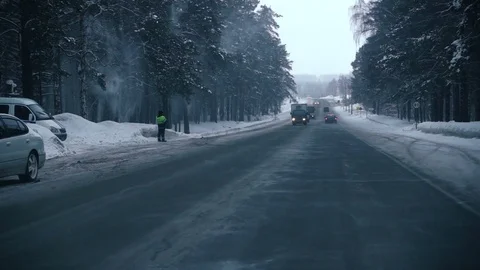 Slow motion traffic on the road in winter forest Stock Footage 72640389