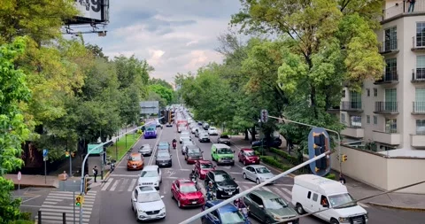 Slow Motion Traffic at an Upscale Mexico City Intersection on a Cloudy Day Stock Footage 338315835