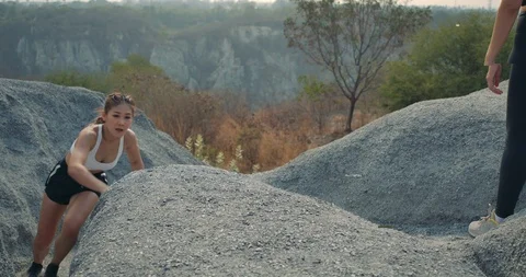 SLOW MOTION, Trail Running partners helping in the rock mountain climb up Video stock 124413454