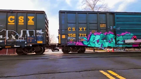 Slow motion train passing through Marietta Square with bright colorful graffiti. Stock Footage 234077456