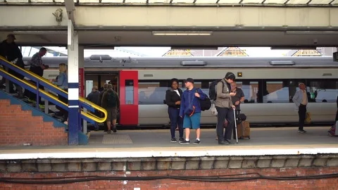 Slow motion: Train station with a busy platform in England, UK. Stock Footage 93931394