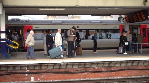 Slow motion: Train station with a busy platform in England, UK. Stock Footage 93931402