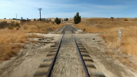 Slow motion train tracks moving rear view of train Stock Footage 88381785
