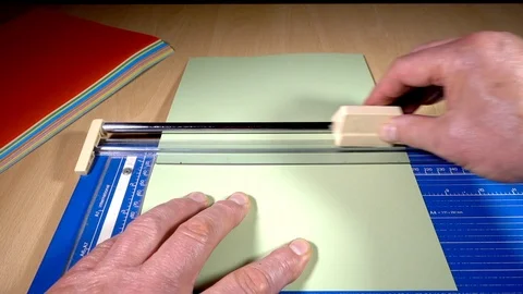 Slow motion – Trimming a piece of thick paper / thin card. Video stock 113676940