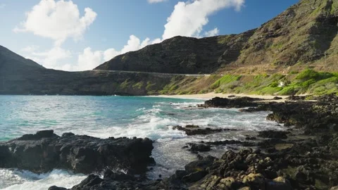 Slow Motion Tropical Beach with Ocean Waves and Green Mountain Stock Footage 326004600
