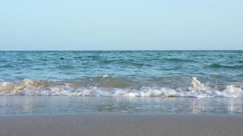 Slow Motion of Turquoise Sea Waves Rolling on Sandy Beach Shoreline. Stock Footage 336795730