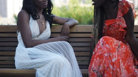 Slow Motion of two African American women talking in bench in Los Angeles Stock Footage 94242317