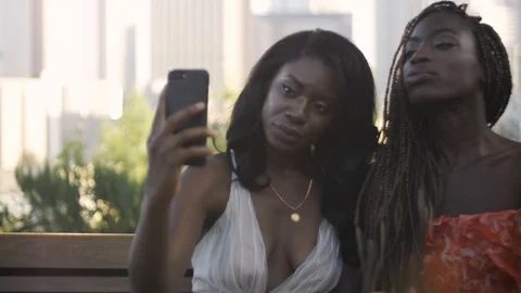 Slow Motion of two African American women taking selfies in Los Angeles Stock Footage 94242732