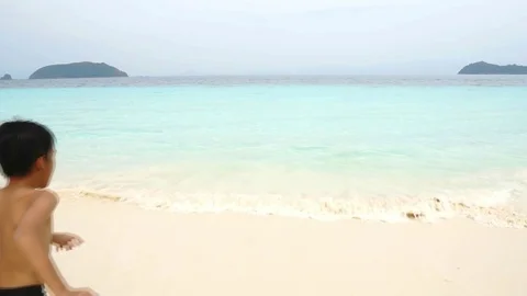 Slow motion two boy run and jump in to blue water of Andaman sea of Mya Stock Footage 87737920