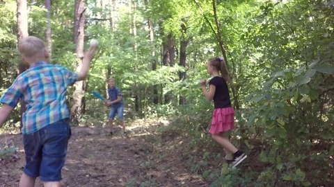 Slow motion. Two boys and  girls in the park practicing baseball. Video stock 78038255