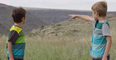 Slow Motion Two Boys in the Hills Looking Into the Distance Stock Footage 61717713