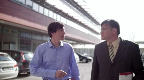 Slow motion of two business men walk and talk friendly Stock Footage 49741097
