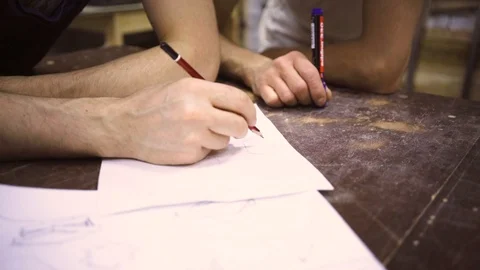Slow Motion: Two carpenters discuss drawing (round wood) in the workshop Stock Footage 102566972