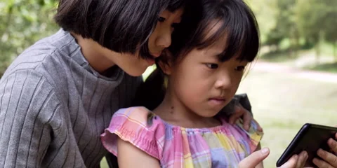 Slow motion two child happy with watch smartphone Stock Footage 162117292