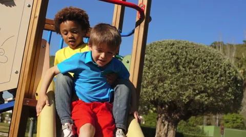 Slow motion of two children on slide in park. Stock Footage 43673387