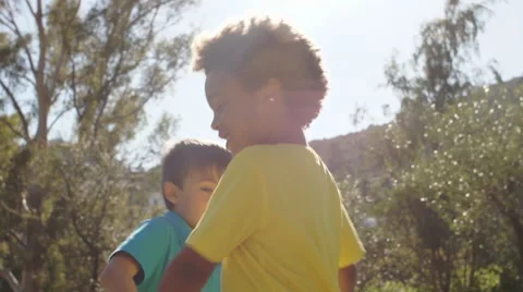 Slow motion of two children twirling in park. Stock Footage 43673546