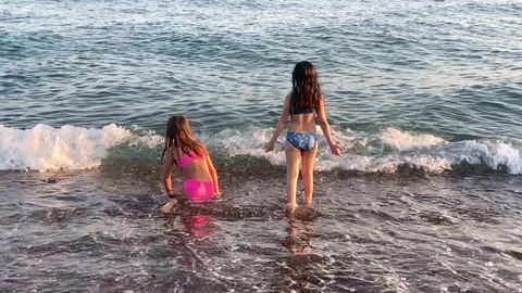 Slow motion of two girls playing by the sea Stock Footage 212035262