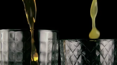 Slow motion. Two glasses filled with orange drinks Stock Footage 75989817