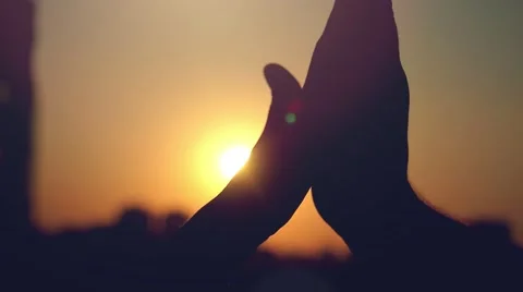 Slow motion of Two hands clap together through the sun on silhouette Of city at Stock-Footage 53298207