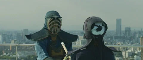 Slow motion of two men practising kendo with wooden katana sword on roof, Tokyo Stock Footage 136122704