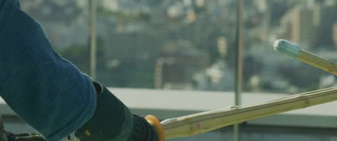 Slow motion of two men practising kendo with wooden katana sword on roof, Tokyo Stock Footage 136122903