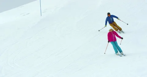 Slow Motion Of Two People Skiing During Wintertime Stock Footage 139448207