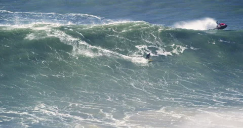 Slow motion of two professional surfers surfing on big ocean waves together Stock Footage 155801869