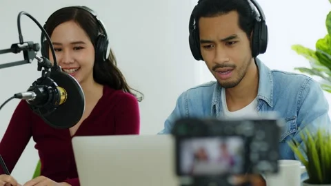 Slow motion of two radio hosts recording podcast in broadcasting studio Stock Footage 150427976