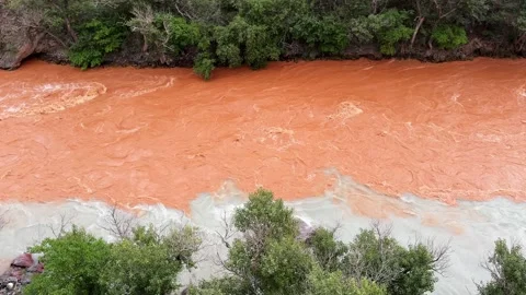 Slow motion of two rivers different colors flowing together without mixing Stock Footage 327631558